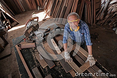 male carpenter uses sandpaper to polish the woodwork Stock Photo