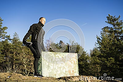 Male caucasian middle age boxer training and strething outside in nature Stock Photo