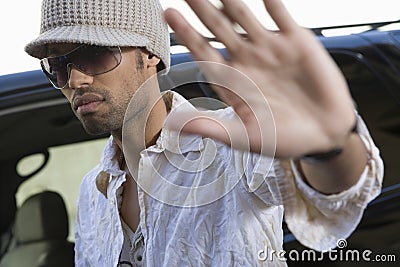 Male Celebrity Shielding Face Stock Photo