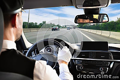 Male chauffeur driving car Stock Photo