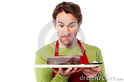 Male chef holding yummy chocolate cake Stock Photo