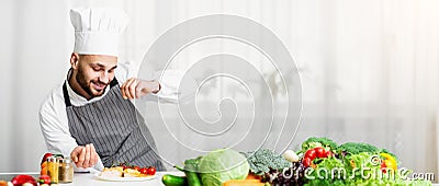 Male Chef Seasoning Roasted Salmon Steak In Kitchen Stock Photo