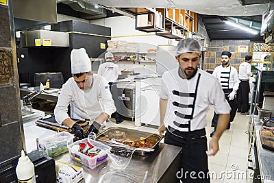 Male chefs in the kitchen prepare meat dishes Editorial Stock Photo