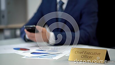 Male chief executive officer using smartphone, reading business news online Stock Photo