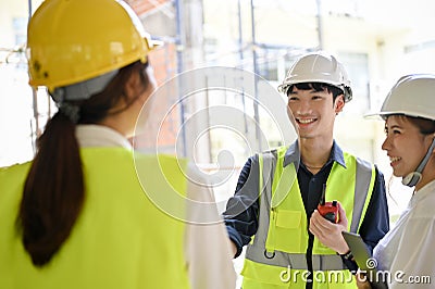 Male civil engineer having a conversation with his construction inspector and architect Stock Photo