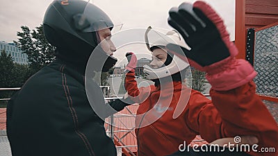 Male coach instructs a skydiver girl before flying into wind tunnel Stock Photo