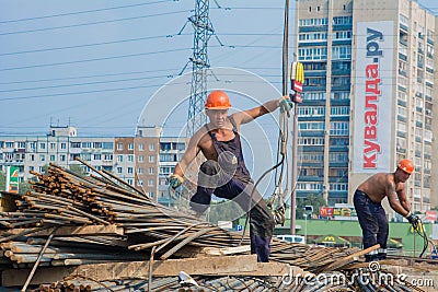 Male construction workers working at a construction site Editorial Stock Photo