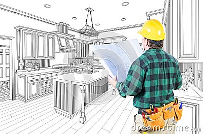 Male Contractor with Hard Hat and Plans in A Custom Kitchen Stock Photo