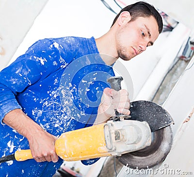 Male contractor using angle grinder Stock Photo