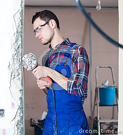 Male contractor using angle grinder Stock Photo