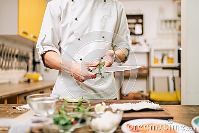Male cook hands closeup, making sushi rolls Stock Photo
