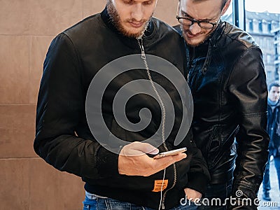 Male couple admiring iPhone X Editorial Stock Photo