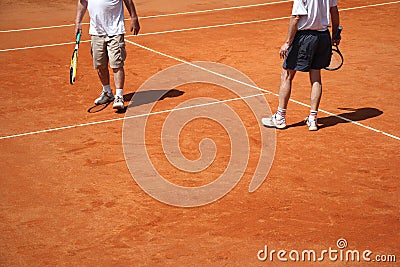 Male couple playing tennis Stock Photo