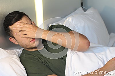 Male covering his face with a hand Stock Photo