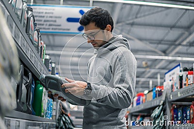 Male customer buying engine lubricating oil in the car supermarket Stock Photo