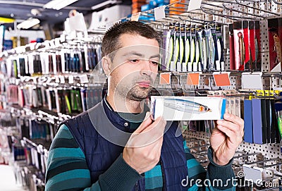 Male customer looking fishing lures Stock Photo