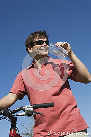 Male Cyclist Drinking Water Stock Photo