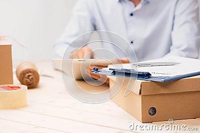 Male deliverer with tablet on work place in post office Stock Photo