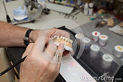 Male dental technician working in dental laboratory Stock Photo