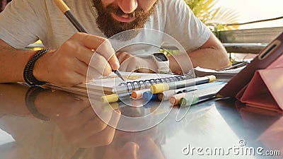 Male designer draw sketches in open air riverside cafe. Stock Photo