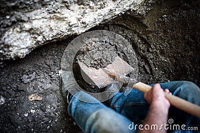 Male digging a hole in the ground with shovel and spade Stock Photo