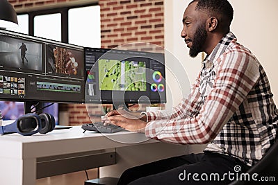 Male digital creator editing video montage Stock Photo