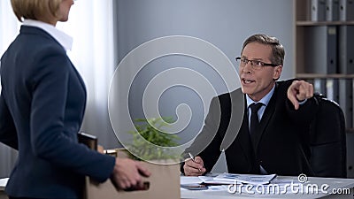 Male director dismisses assistant, incompetent unprofessional worker, lay-off Stock Photo