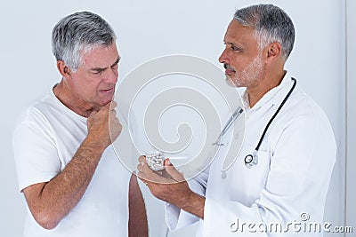 Male doctor advising senior man on medical prescriptions Stock Photo