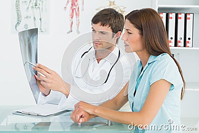 Male doctor explaining lungs xray to female patient Stock Photo