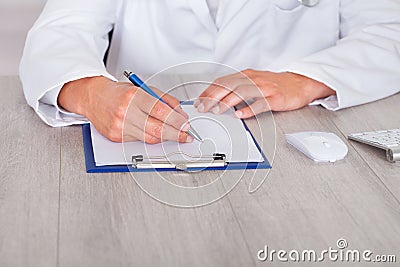 Male doctor filling form Stock Photo