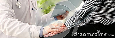 Male doctor hold pacient female arm Stock Photo