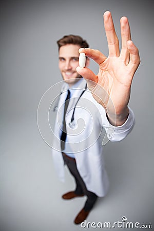A male Doctor holding pill medical health care pharmacy concept. Stock Photo
