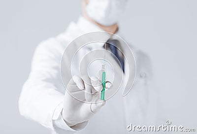 Male doctor holding syringe with injection Stock Photo