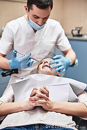 Release your smile. The dentist is going to make a painkiller injection to his female patient. Stock Photo