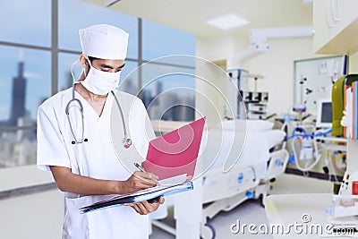 Male doctor making notes Stock Photo