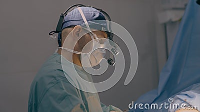 Male doctor man surgeon physician neurosurgeon practitioner medic in medical mask perform surgical operation in Stock Photo