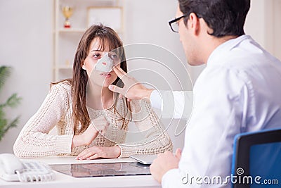 The male doctor talking to patient with nose operation surgery Stock Photo