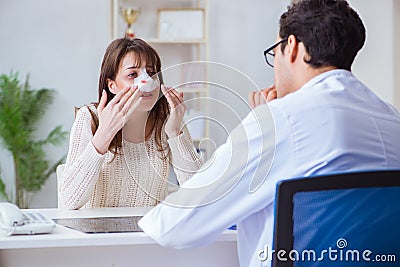 The male doctor talking to patient with nose operation surgery Stock Photo