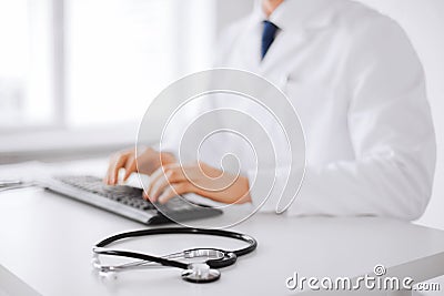 Male doctor typing on the keyboard Stock Photo