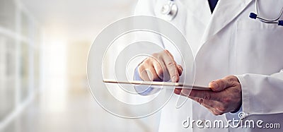 Male doctor using his digital tablet Stock Photo
