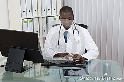 Male Doctor Working On Computer Stock Photo