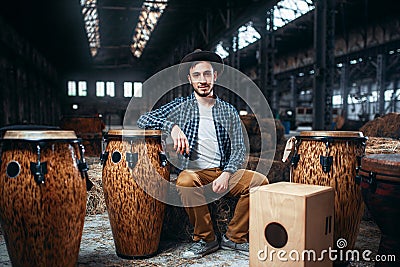 Male drummer pose against african wooden drum Stock Photo