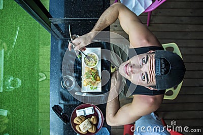 Male eating in cafe, seen from above Stock Photo