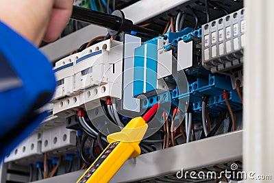 Male Electrician Checking Fusebox Stock Photo