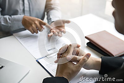 Male employee is explaining to the manager while being interviewed in the office room Stock Photo