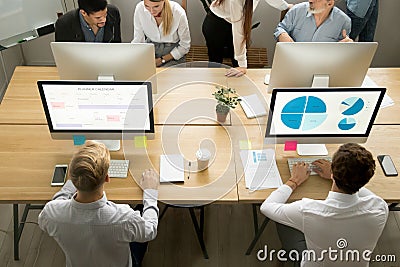 Employees using computers working with staff in office, top view Stock Photo