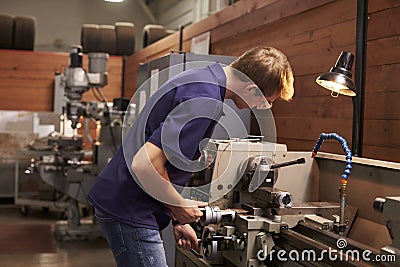 Male Engineer In Factory Using Milling Machine Stock Photo