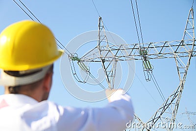 Male engineer standing at electricity station Stock Photo