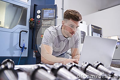 Male Engineer Using CAD Programming Software On Laptop Stock Photo