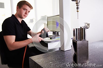 Male Engineer Using CAD System To Work On Component Stock Photo